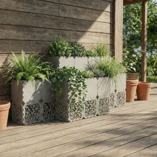 Grey Cubik layered grid planter on a wooden deck, planted with ferns and succulents