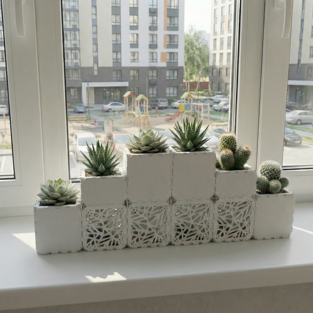 White Cubik table garden set, close-up on a windowsill