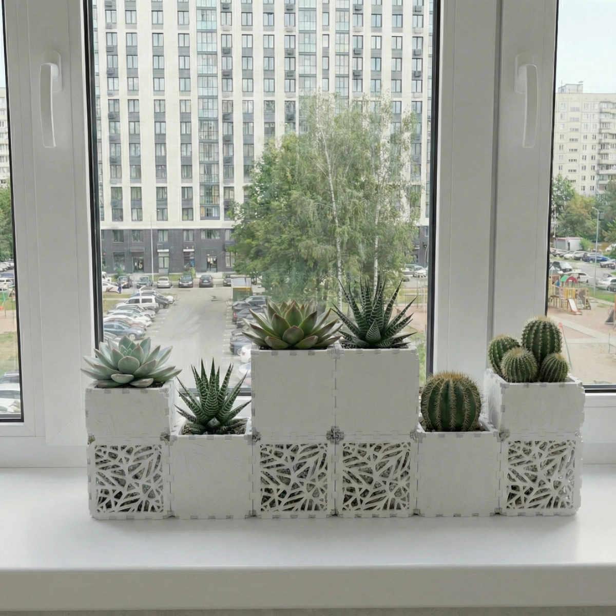 White Cubik table garden set with succulents on a windowsill