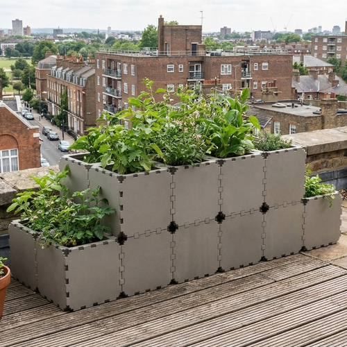 Grey Cubik modular tiered planter on a city rooftop terrace