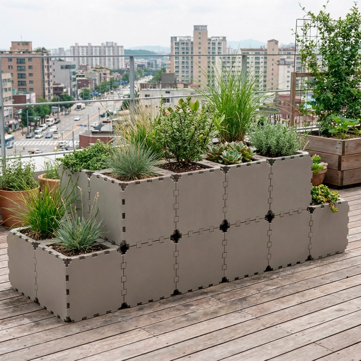 Grey Cubik modular tiered planter on a wooden rooftop deck